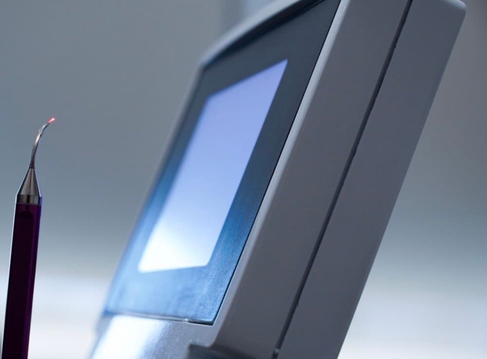 The tip of a dental laser handpiece with its aiming beam