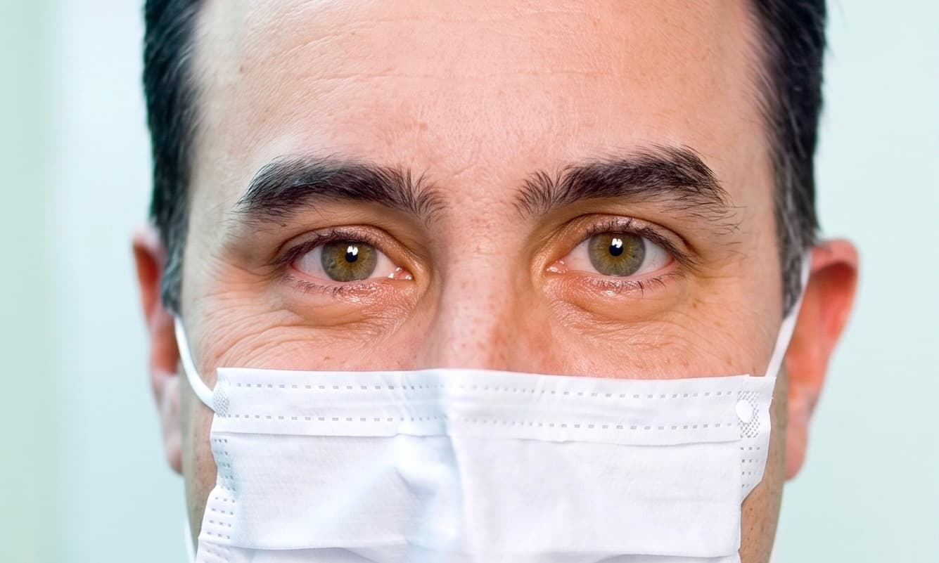 Dr. Conte's focused gaze above a surgical mask