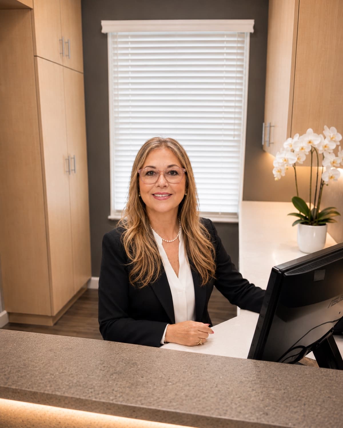 A member of our team welcoming patients at the reception desk