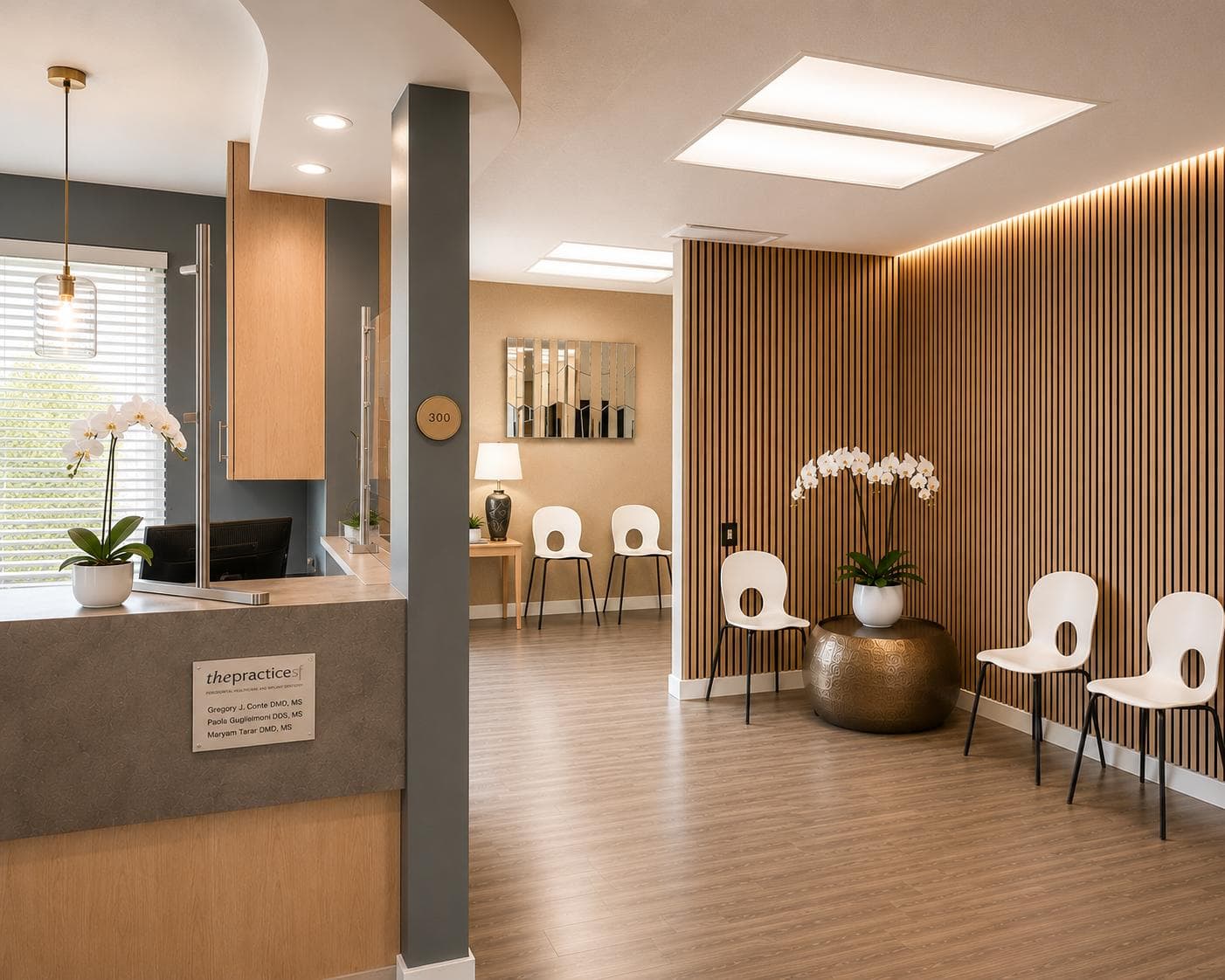 The reception and waiting room of The Practice SF, with orchids and a wood-slat wall